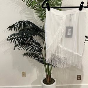 White swimsuits cover up skirt.